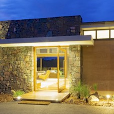 Rammed earth and staked stone house