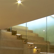 cantilevered stairs, concrete wall, timber, glass balustrade